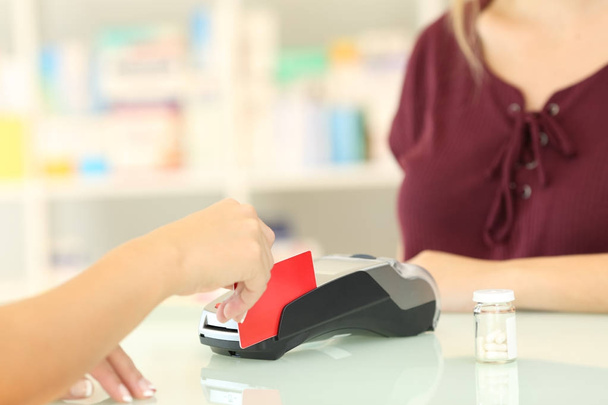 Pharmacist charging with credit card in a pharmacy - Photo, image