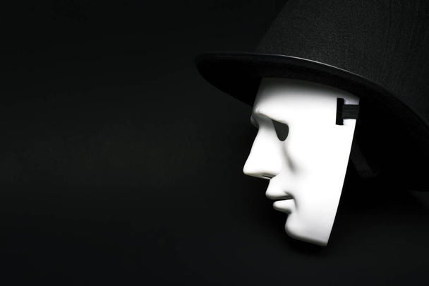 White human mask in hat - 写真・画像