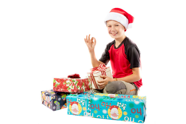 Pre-teen boy and a selection of Christmas gifts - Фото, изображение