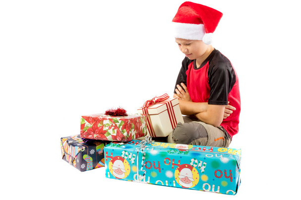 Pre-teen boy and a selection of Christmas gifts - Photo, image