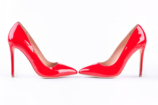 Fashionable red high heels over white. - Foto, afbeelding
