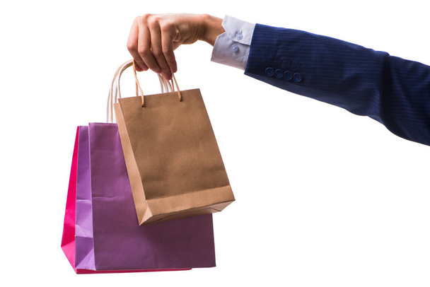 Hand holding shopping bags with christmas shopping on white back - Foto, imagen