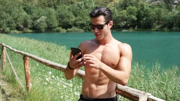 Man doing videochat at lake - Video, Çekim