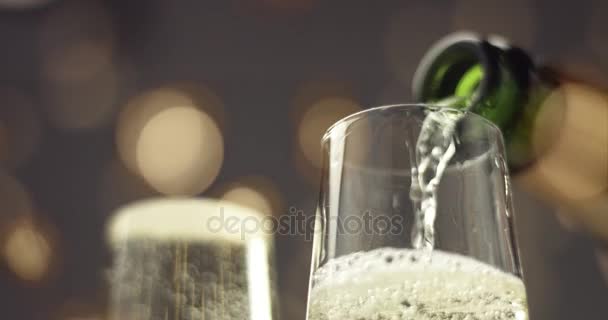 Pouring champagne into a flute glass - Materiaali, video