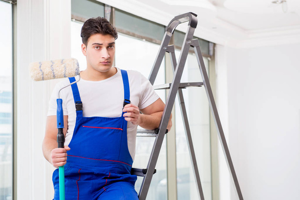 Painter repairman working at construction site - Foto, Imagen