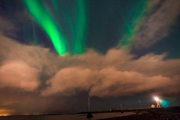 Northern lights Aurora Borealis above landscape in Iceland with - Photo, Image