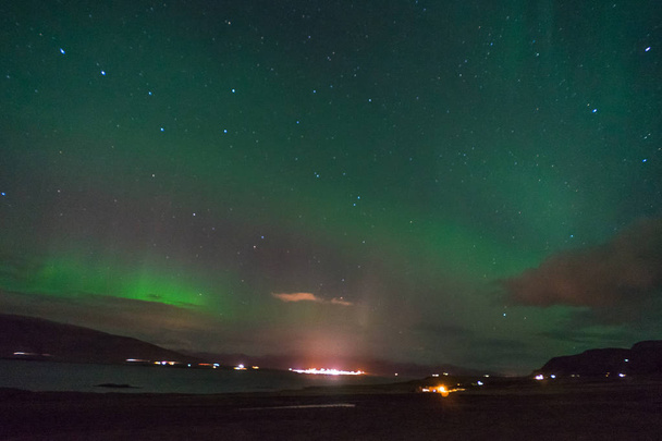 Northern lights Aurora Borealis above landscape in Iceland - Photo, Image