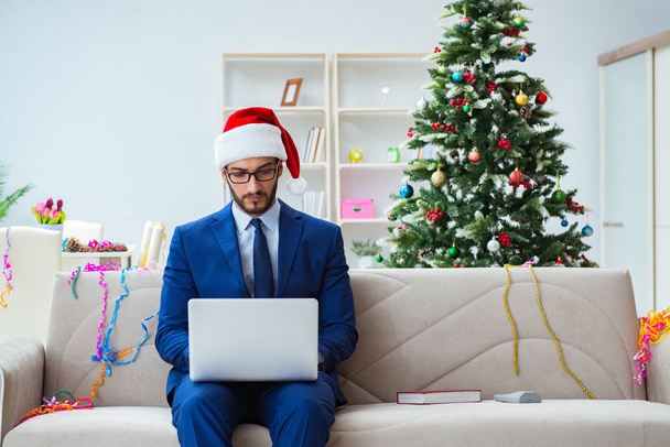 Businessman working at home during christmas - Photo, image