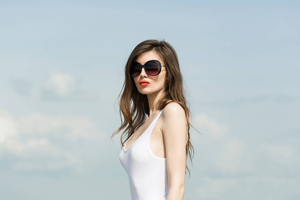 Fashion model on blue sky background. - Photo, Image