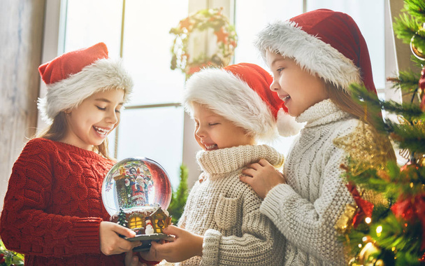 children with snow globe - Photo, image