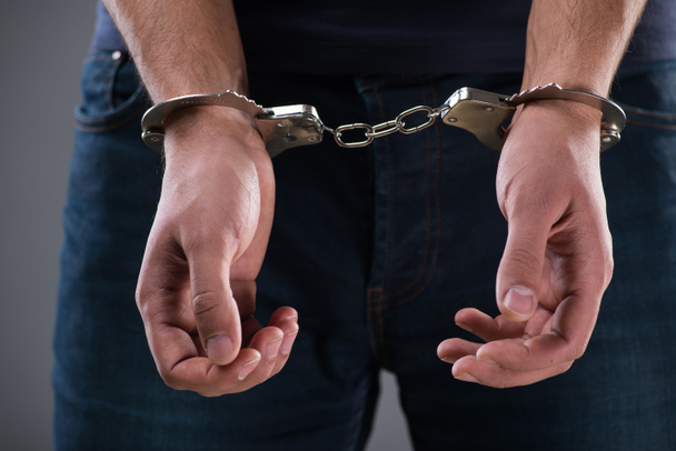 Человек с наручниками в наручниках в преступной концепции - Фото, изображение
