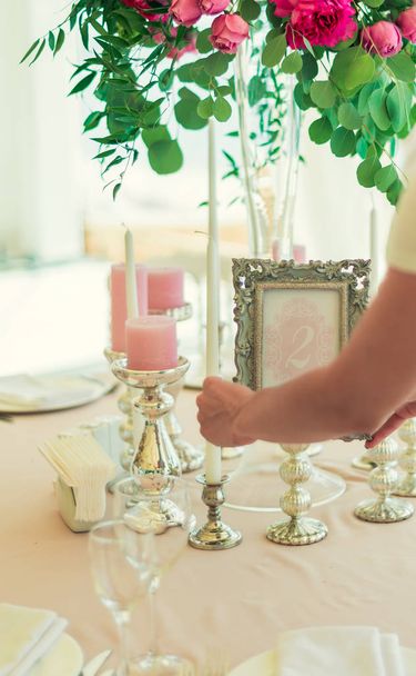 a girl, a woman decorates a wedding festive table - 写真・画像