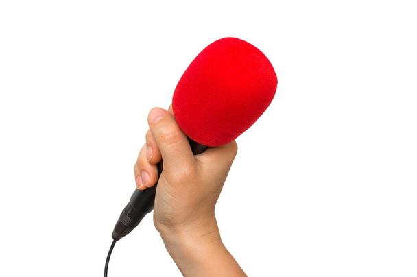 Hand der Frau mit rotem Mikrofon isoliert auf weiß - Foto, Bild