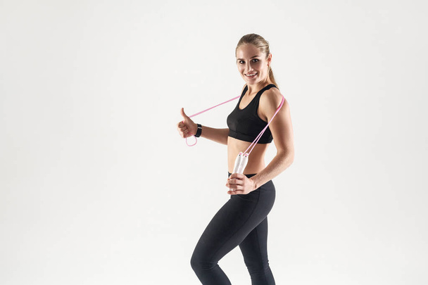 athletic woman holding skipping rope - Фото, изображение
