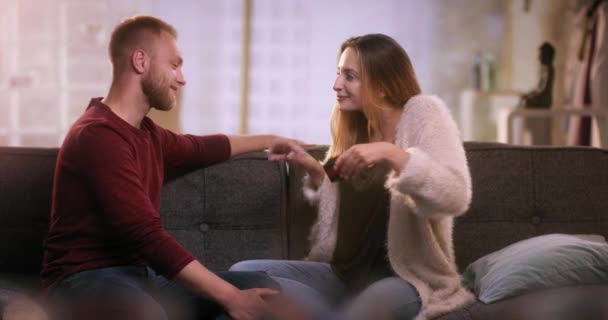 Cute girl is handing little gift box to her boyfriend - Video, Çekim