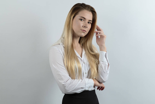 elegant young business lady posing for a portrait in a relaxed a - Foto, Bild