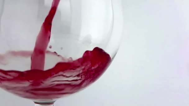 muž vylévající červené víno do nápojového skla na bílém pozadí, koncepce zdravotní péče-výživa, Střelba s vysokorychlostní kamerou  - Záběry, video