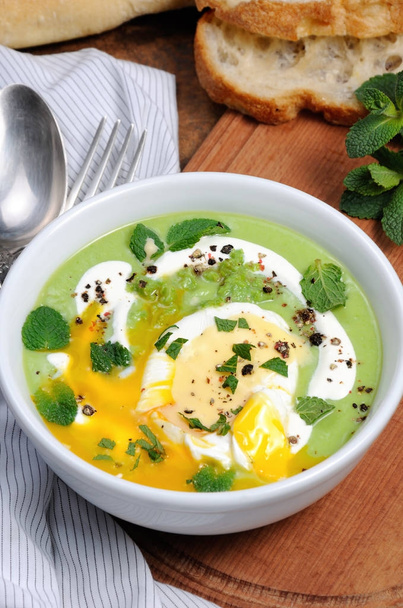 Pea puree soup with poached egg  and peppermint - Photo, Image