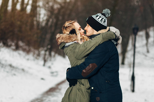 couple kissing in winter park - Photo, image