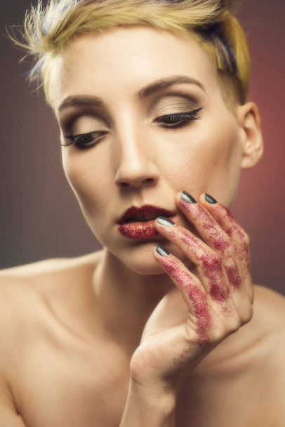 Young Woman With Glittered Hands And Lips - 写真・画像