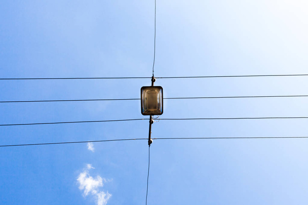 Electrical wires against the blue cloudy sky - Photo, Image