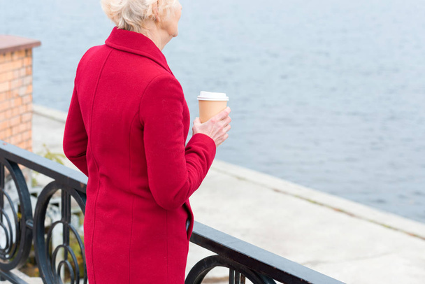senior woman with coffee on quay - Photo, Image