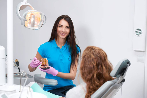 Professional female dentist at work - Foto, imagen