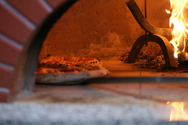 Neapolitan pizza in a wood stove - Photo, Image