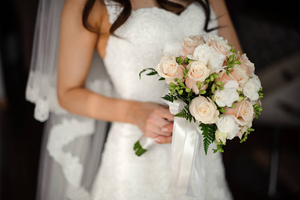 Bride in a beautiful white dress holding a bouquet - Φωτογραφία, εικόνα