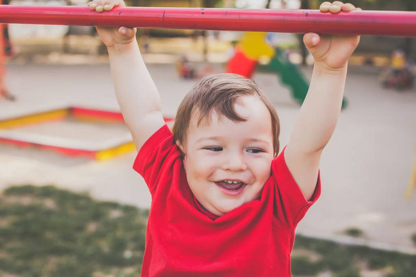 cute boy smiling and playing on playground - Foto, Imagem