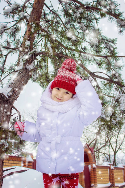 A child plays in the snow in the winter. Selective focus. - Photo, Image