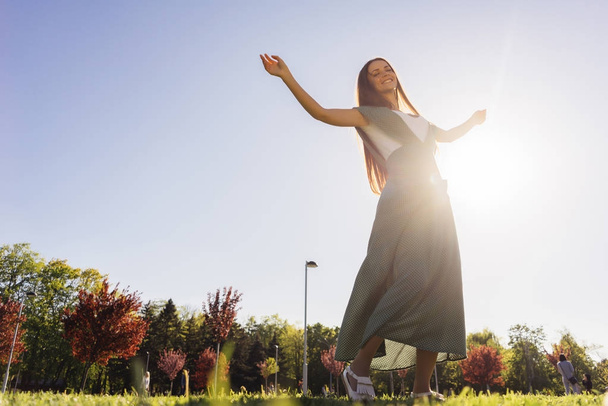 Joyful and happy woman outdoor,raised arms,freedom summer - Фото, изображение