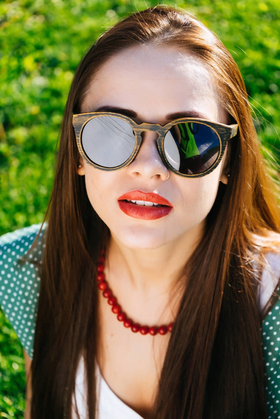 Close up woman face in sunglasses,wooden glasses,whitening - Foto, immagini