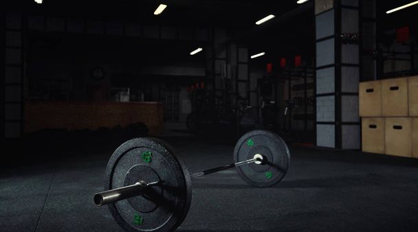 Heavy barbell on the floor of a gym studio - Foto, imagen
