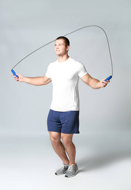 Young man with jumping rope - Photo, image