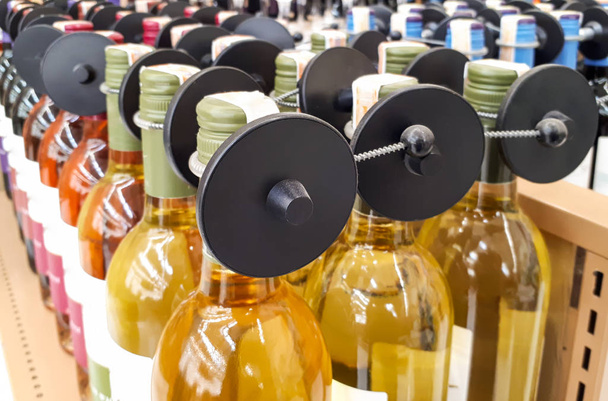 rfid Hard Etikett isoliert - Ladendiebstahl- und Diebstahlschutz - elektronisches Artikelüberwachungssystem für hochwertige Waren - Flasche mit alkoholischen Getränken - Foto, Bild