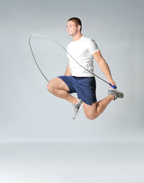 Young man with jumping rope - Фото, изображение