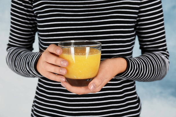 Woman holding glass with yellow smoothie  - Foto, immagini