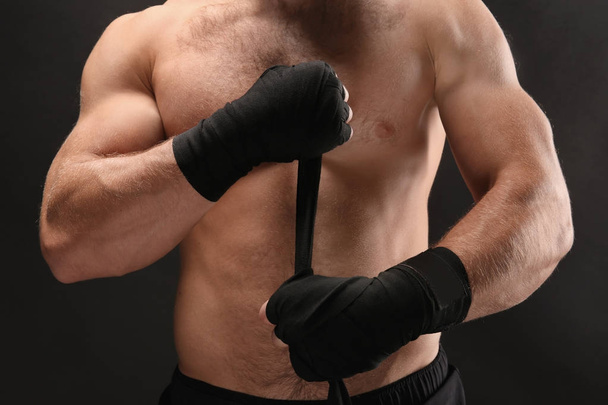 Male boxer applying wrist wraps  - Foto, imagen