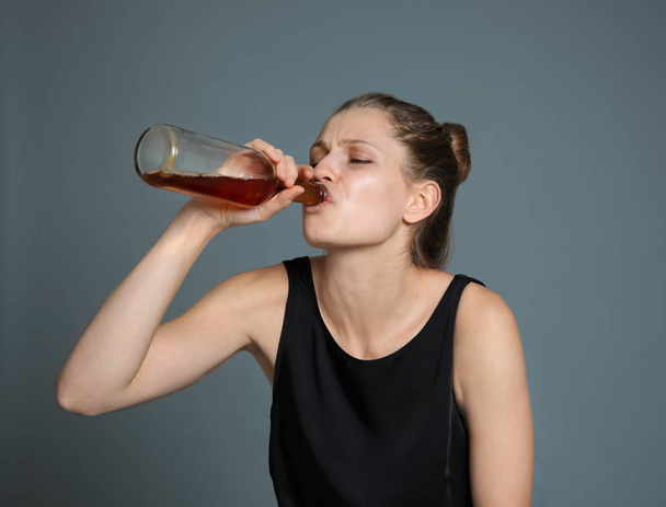 Young woman drinking alcohol  - Фото, изображение