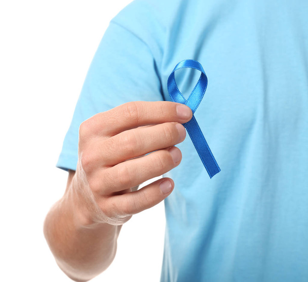 Young man holding blue ribbon  - Photo, Image