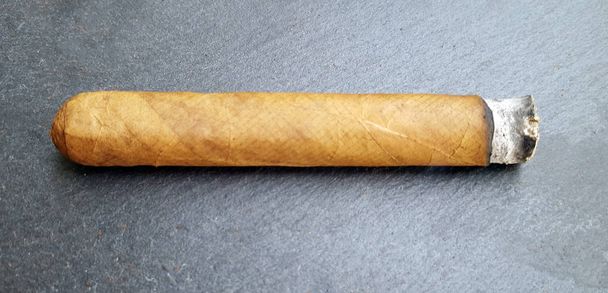 Cuban cigar burned on dark background - Photo, Image