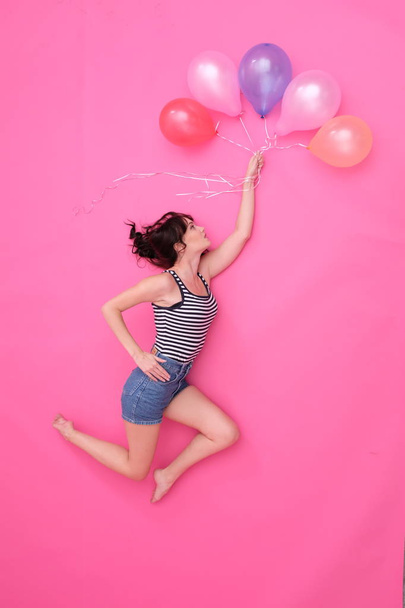 Pretty female is playing with balloons. - Fotoğraf, Görsel