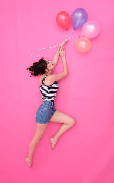 Girl flying on balloons. - Фото, зображення