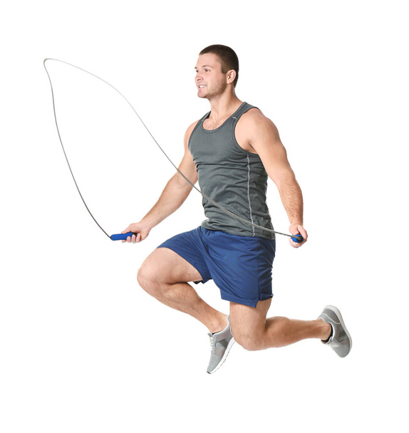 Young man with jumping rope on white background - Foto, Bild