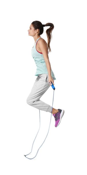 Young woman with jumping rope - Foto, imagen