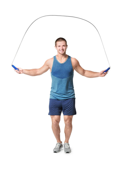 Young man with jumping rope on white background - Фото, изображение