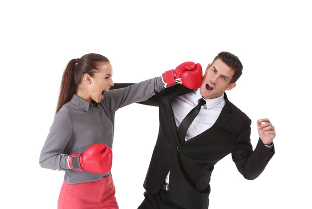 Woman in boxing gloves hitting businessman - Фото, зображення