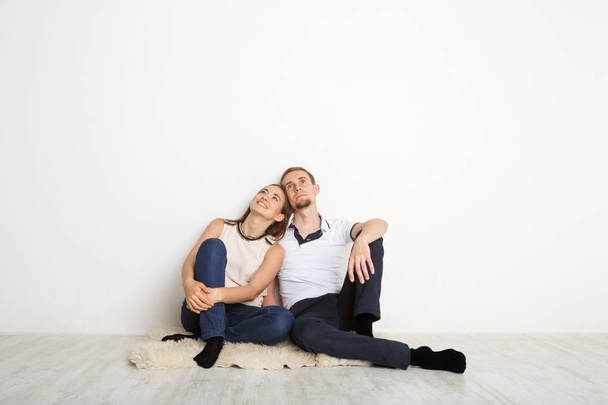 Couple looking up at white background - Photo, Image
