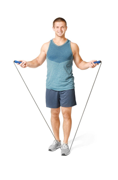 Young man with jumping rope on white background - Photo, Image